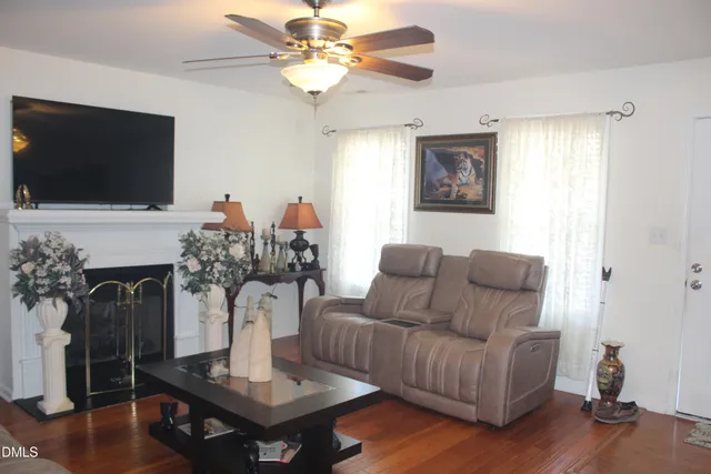 a living room with furniture fireplace and flat screen tv