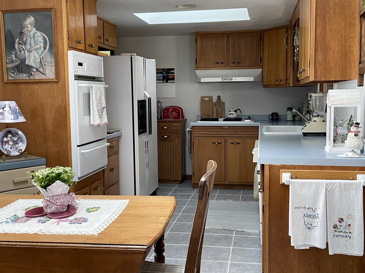 216 Pauline Drive Elgin, IL 60123 - Photo 9 of 20 a kitchen with stainless steel appliances granite countertop a refrigerator and a stove top oven