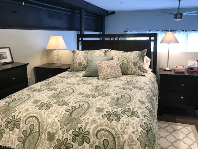 a bedroom with a bed and a lamp