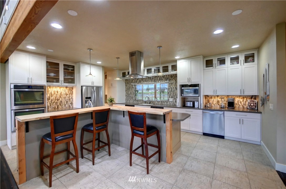 81 Jaquish Road Omak, WA 98841 - Photo 11 of 40 a large kitchen with a table and chairs in it