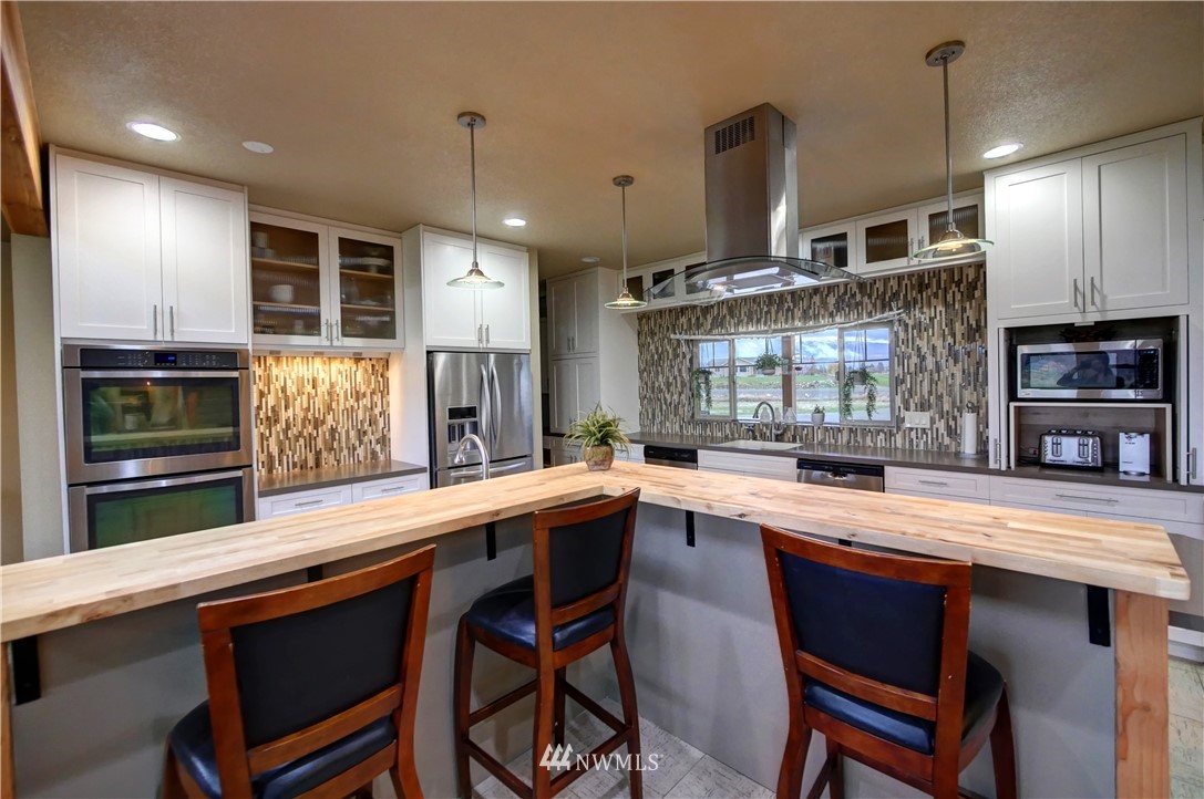 81 Jaquish Road Omak, WA 98841 - Photo 12 of 40 a kitchen with stainless steel appliances a sink and stove