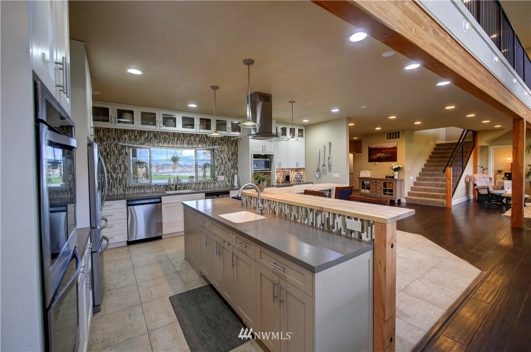 81 Jaquish Road Omak, WA 98841 - Photo 14 of 40 a kitchen with stainless steel appliances granite countertop a large counter top a stove and a refrigerator