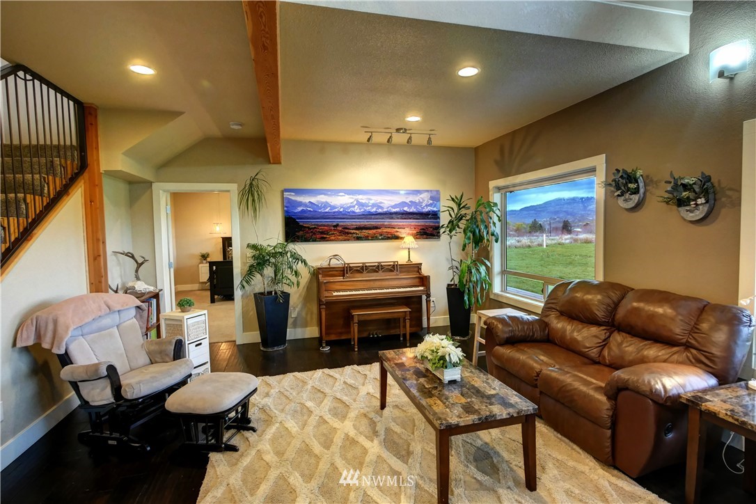 81 Jaquish Road Omak, WA 98841 - Photo 22 of 40 a living room with furniture fireplace and a flat screen tv