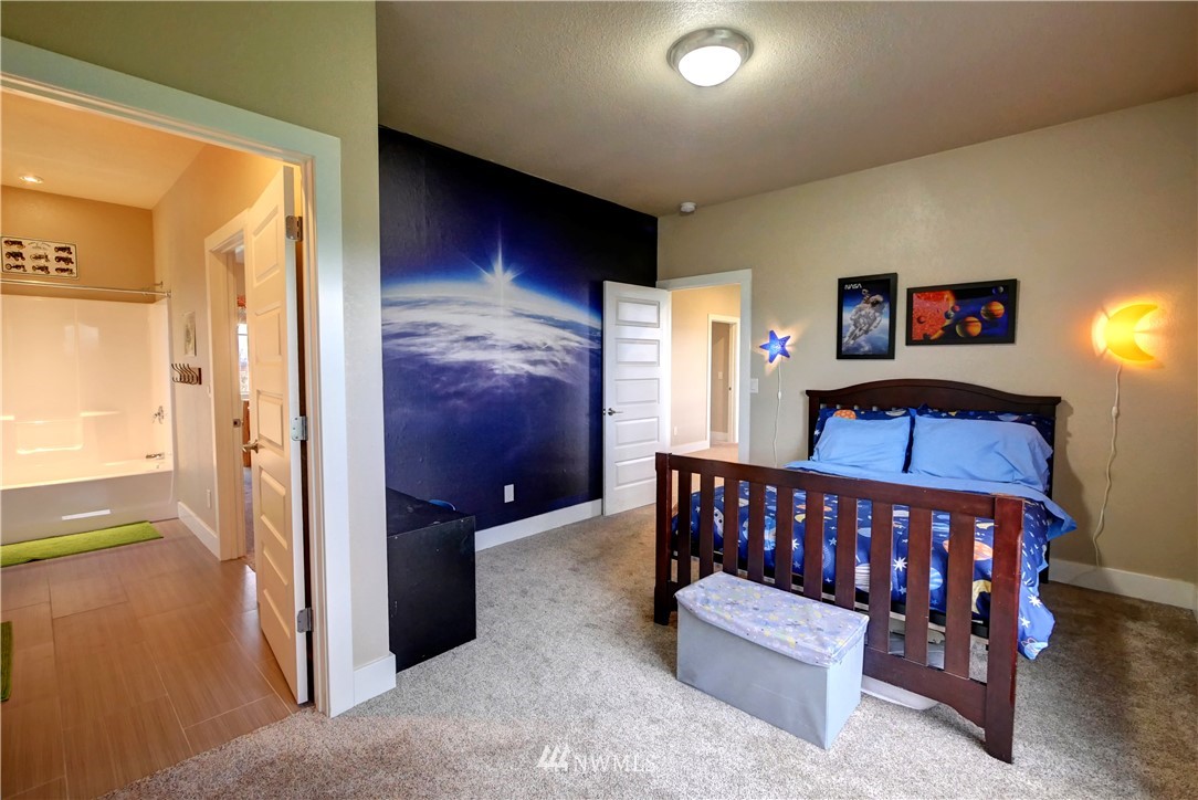 81 Jaquish Road Omak, WA 98841 - Photo 35 of 40 a bedroom with furniture and a flat screen tv