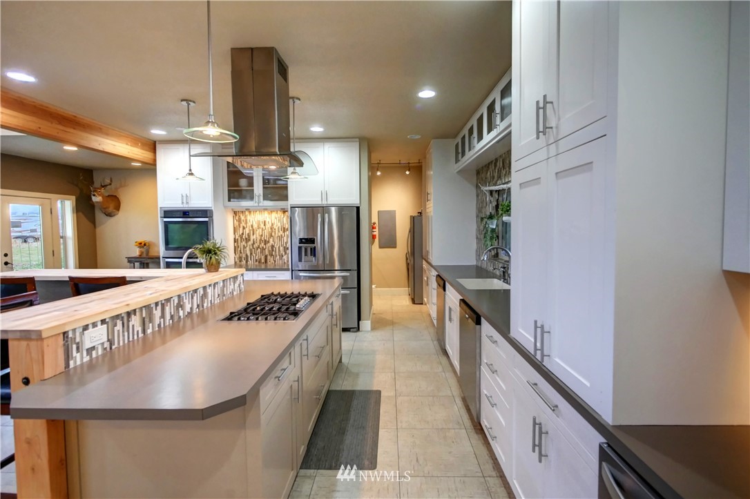 81 Jaquish Road Omak, WA 98841 - Photo 10 of 40 a kitchen with stainless steel appliances granite countertop a sink and cabinets