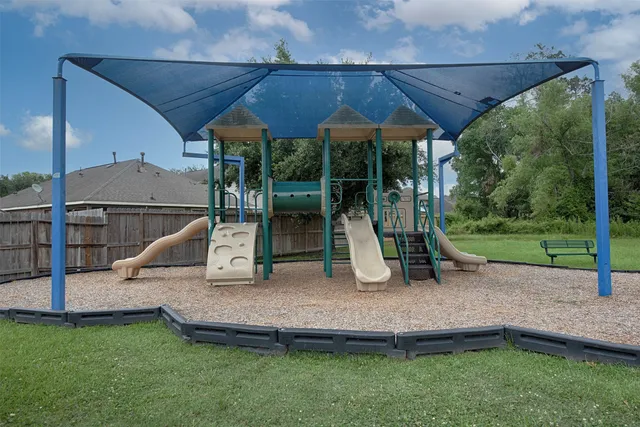 a kitchen with stainless steel appliances kitchen island granite countertop a sink and white cabinets