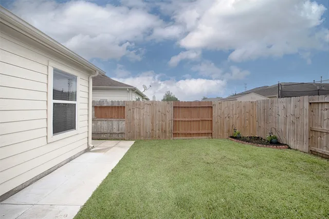 a view of a big room with wooden floor and a ceiling fan