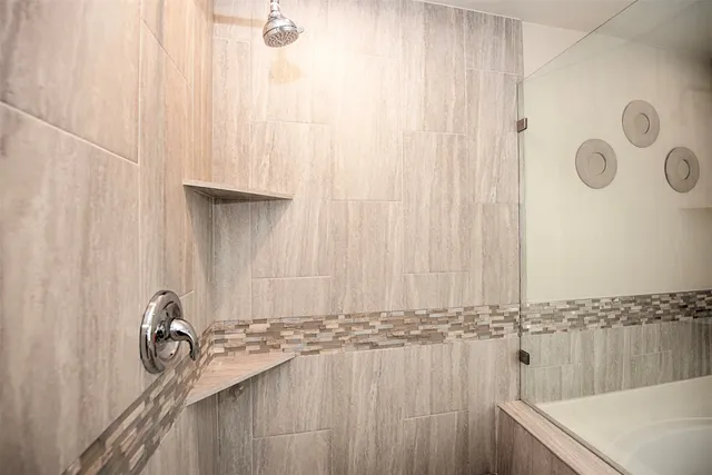 a kitchen with stainless steel appliances granite countertop a sink a stove and a refrigerator