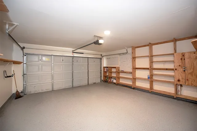 a large kitchen with granite countertop a large counter top stainless steel appliances and cabinets