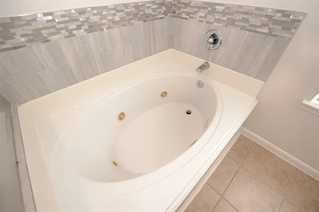 a large kitchen with granite countertop a sink and dishwasher a stove top oven with wooden floor