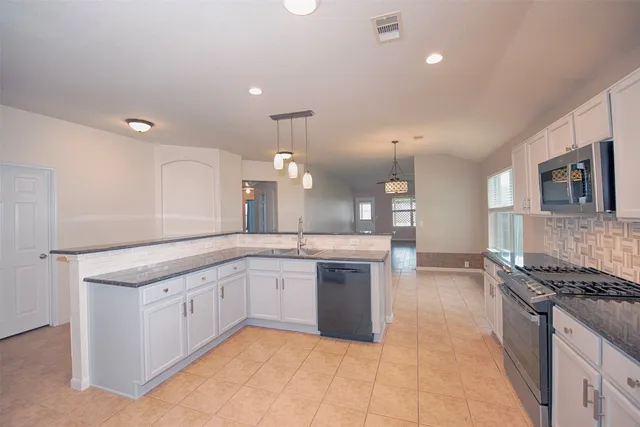 a bathroom with a granite countertop sink a large mirror and a shower