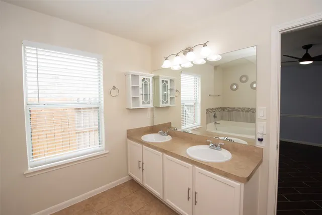 a view of a backyard with table and chairs and wooden fence