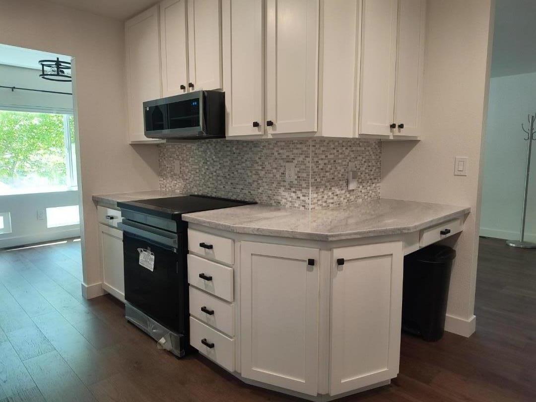 552 Bean Creek Road, Unit 126 Scotts Valley, CA 95066 - Photo 3 of 34 a kitchen with stainless steel appliances white cabinets and a wooden floor