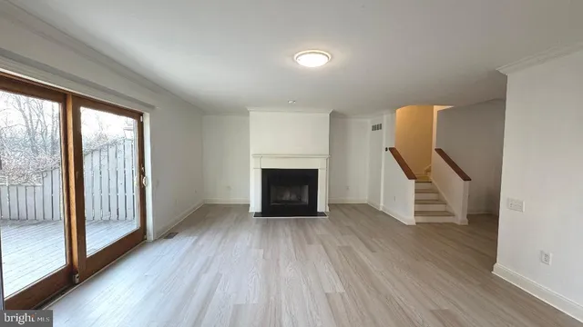 wooden floor in an empty room with a fireplace
