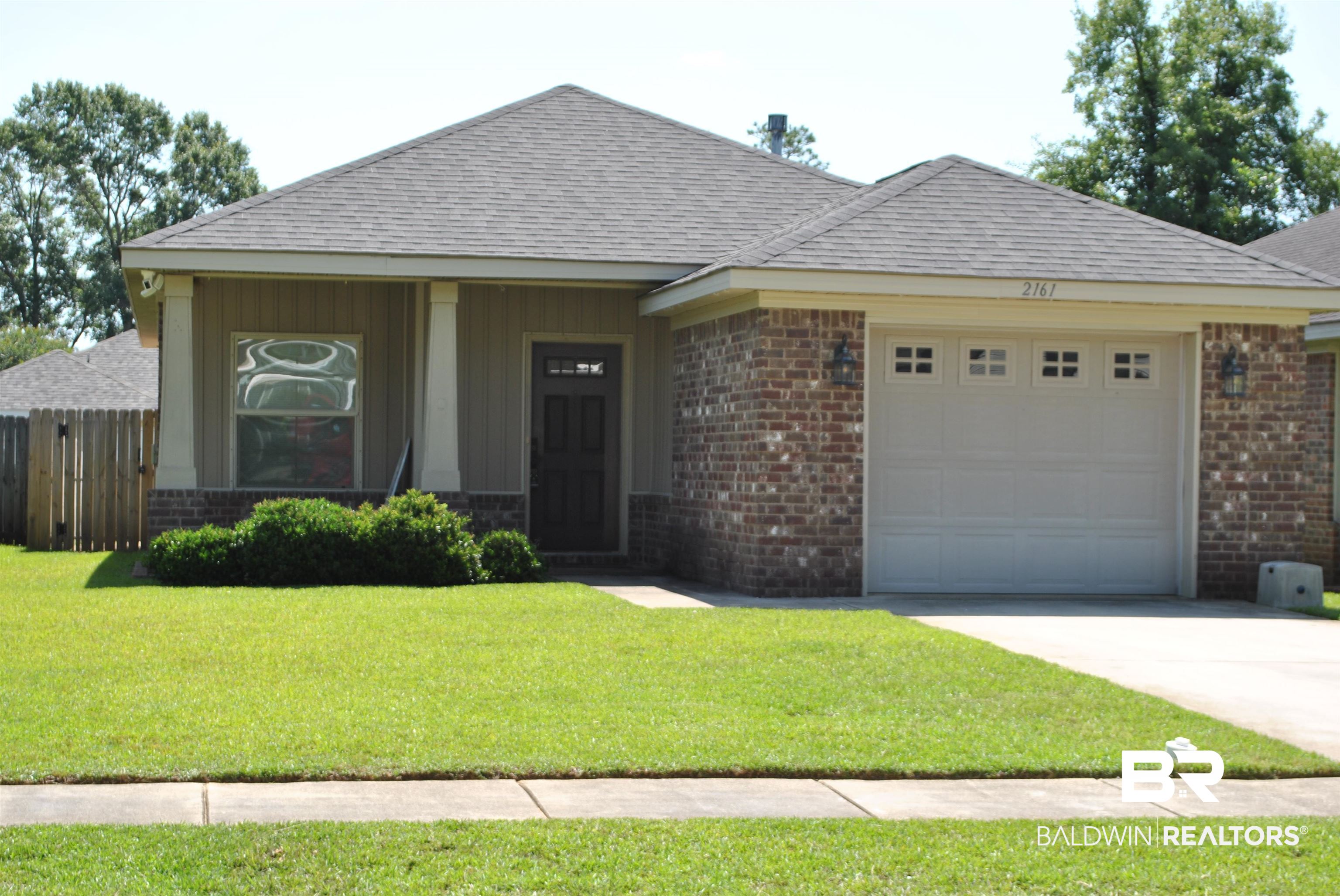 2161 Spring Grove West Mobile, AL 36695 - Photo 1 of 31 Ranch-style house featuring brick siding, concrete driveway, a garage, and a shingled roof