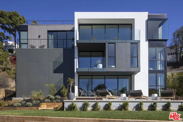a view of a chairs and fire pit in the back yard