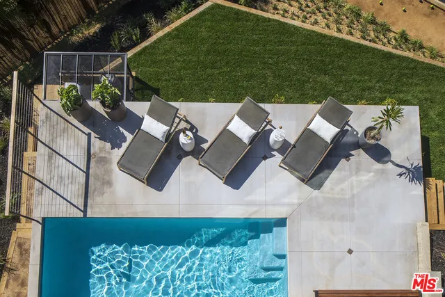 an aerial view of a house with a yard