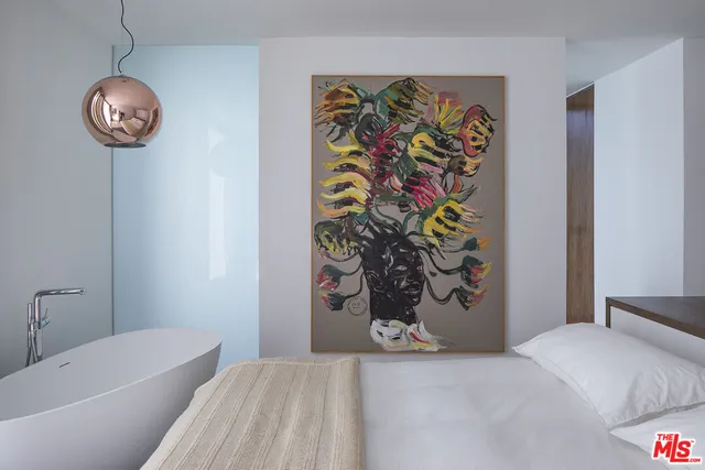 a bedroom with a bed and a table