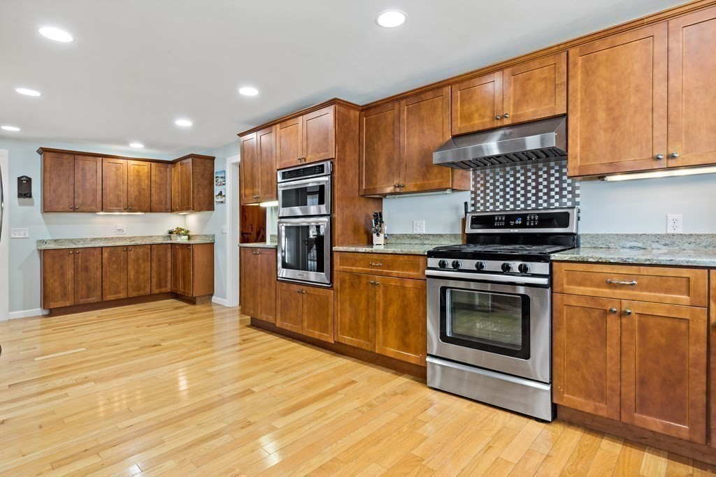 482 Delano Road Marion, MA 02738 - Photo 11 of 35 a kitchen with stainless steel appliances granite countertop a stove a sink and a refrigerator