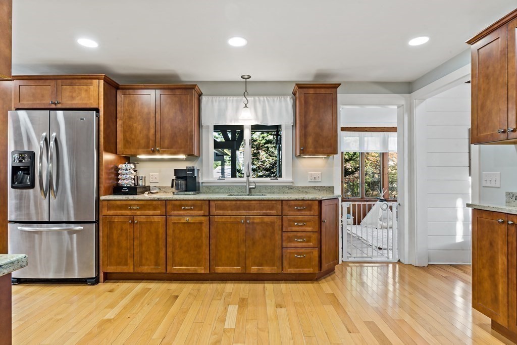 482 Delano Road Marion, MA 02738 - Photo 15 of 35 a large kitchen with stainless steel appliances wooden floors and wooden cabinets
