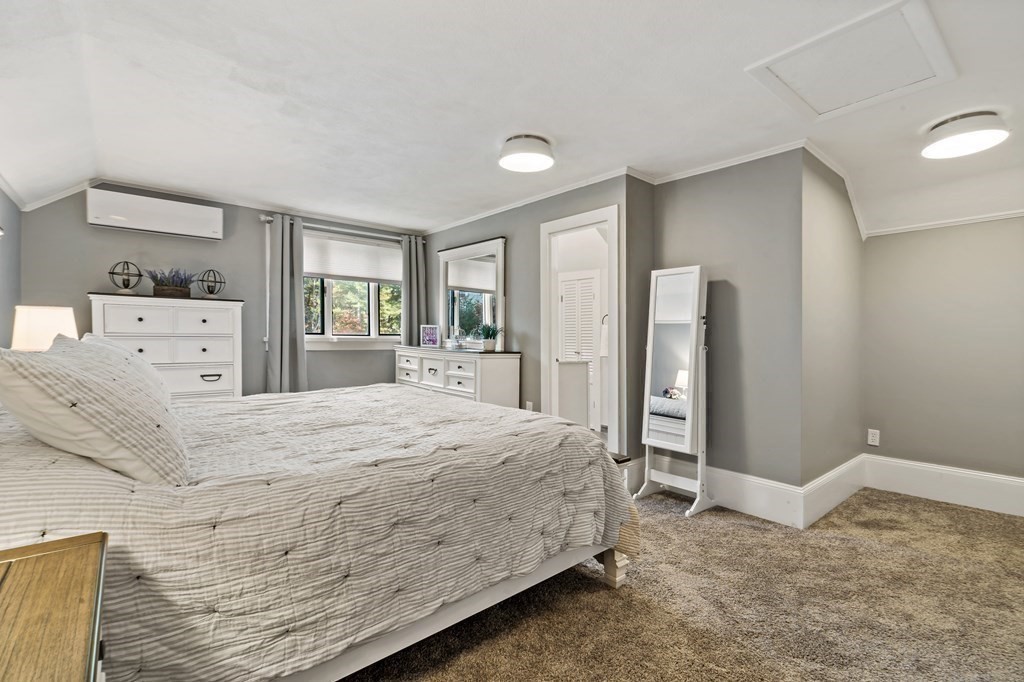 482 Delano Road Marion, MA 02738 - Photo 23 of 35 a bedroom with a bed and a large mirror