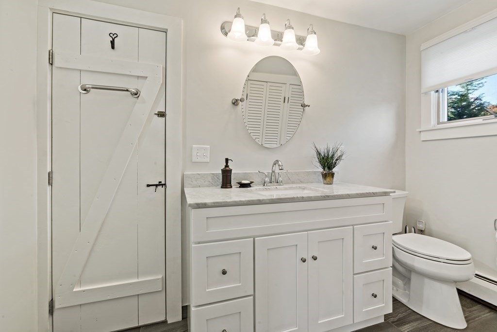 482 Delano Road Marion, MA 02738 - Photo 24 of 35 a bathroom with a sink a toilet and a mirror