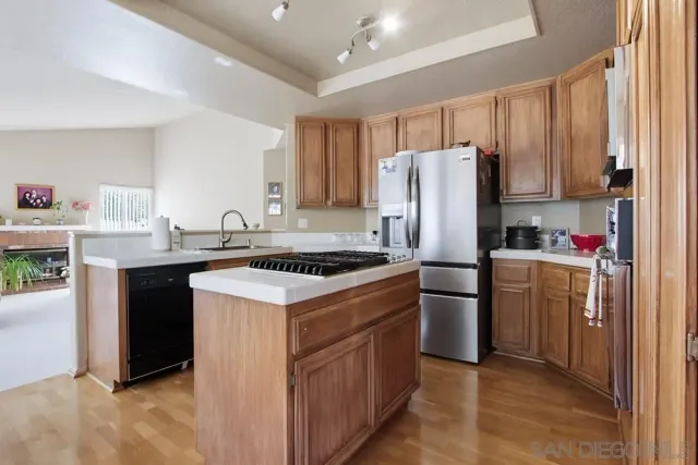 a kitchen with a sink stove and refrigerator