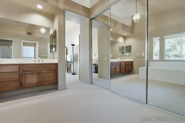 a large bathroom with a glass door shower sink and mirror