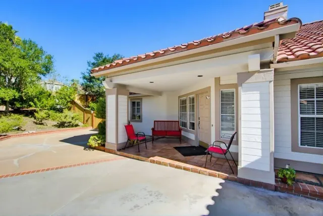a view of a patio with table and chairs and potted plants