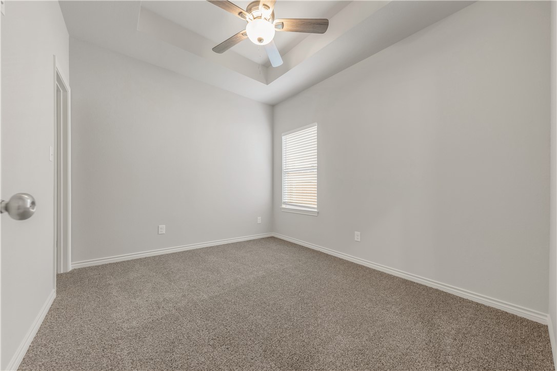 1803 Pin Oak Street Bryan, TX 77803 - Photo 11 of 17 an empty room with windows and fan