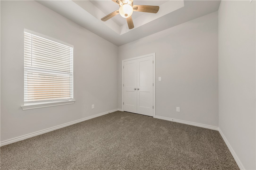 1803 Pin Oak Street Bryan, TX 77803 - Photo 13 of 17 an empty room with a window and a ceiling fan