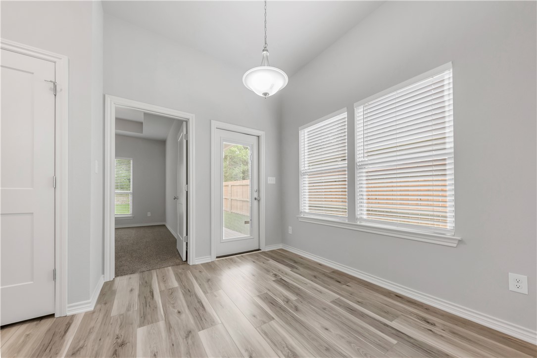 1803 Pin Oak Street Bryan, TX 77803 - Photo 5 of 17 a view of empty room with wooden floor and fan