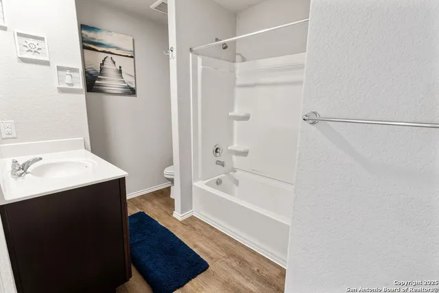 a bathroom with a bathtub a shower a sink and a toilet