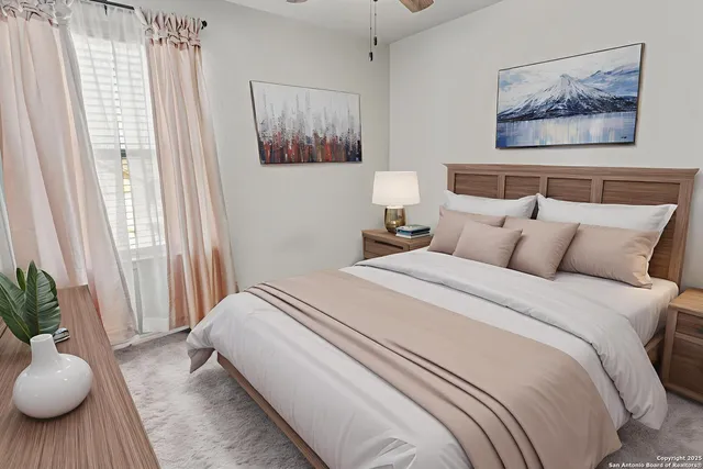 a bedroom with bed and paintings on the wall