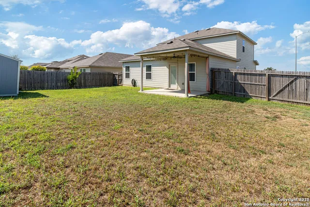 a view of a house with backyard and a garden