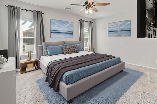 a bedroom with a bed and a painting on the wall