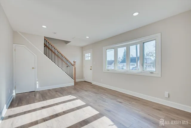 a view of an entryway with wooden floor