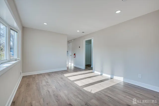 a view of a room with wooden floor and window