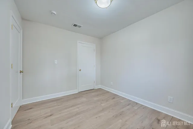 a bathroom with a sink vanity granite toilet and a mirror