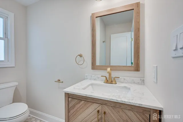 a white toilet sitting next to a bathroom sink