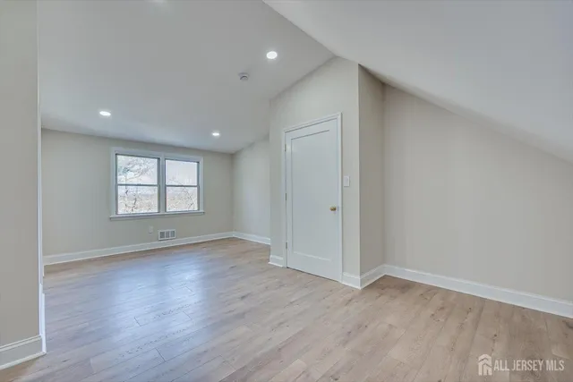 a view of an empty room and wooden floor