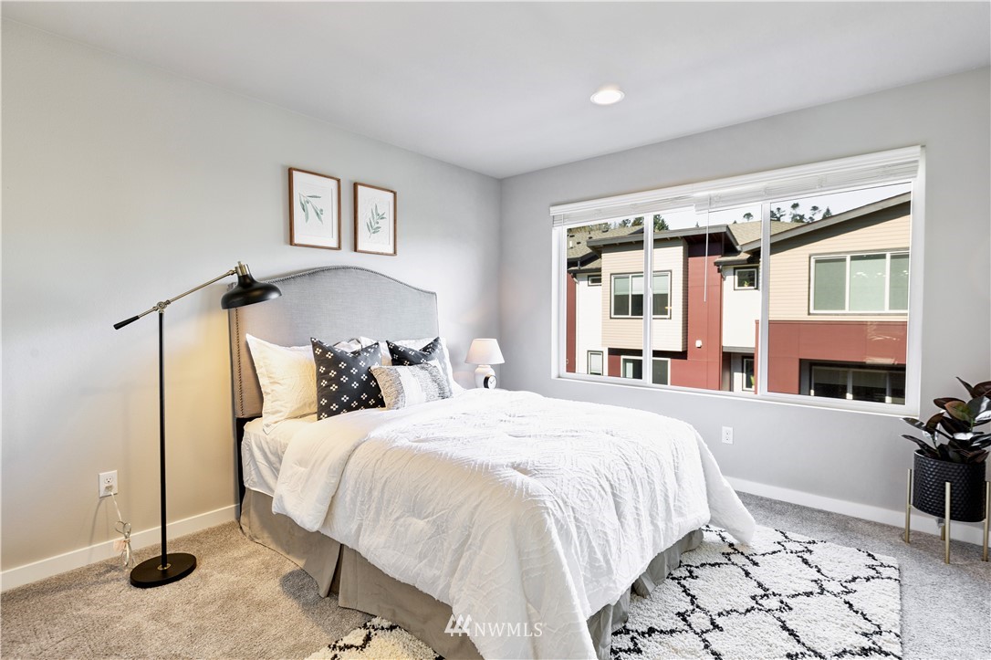 518 238th Street Southeast, Unit B Bothell, WA 98021 - Photo 21 of 24 a bedroom with a large bed and a dresser