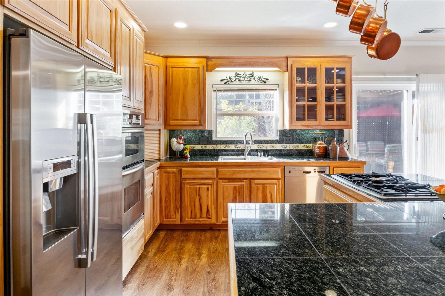 476 Fiddler Court Angels Camp, CA 95222 - Photo 14 of 40 a kitchen with stainless steel appliances granite countertop a sink and a refrigerator