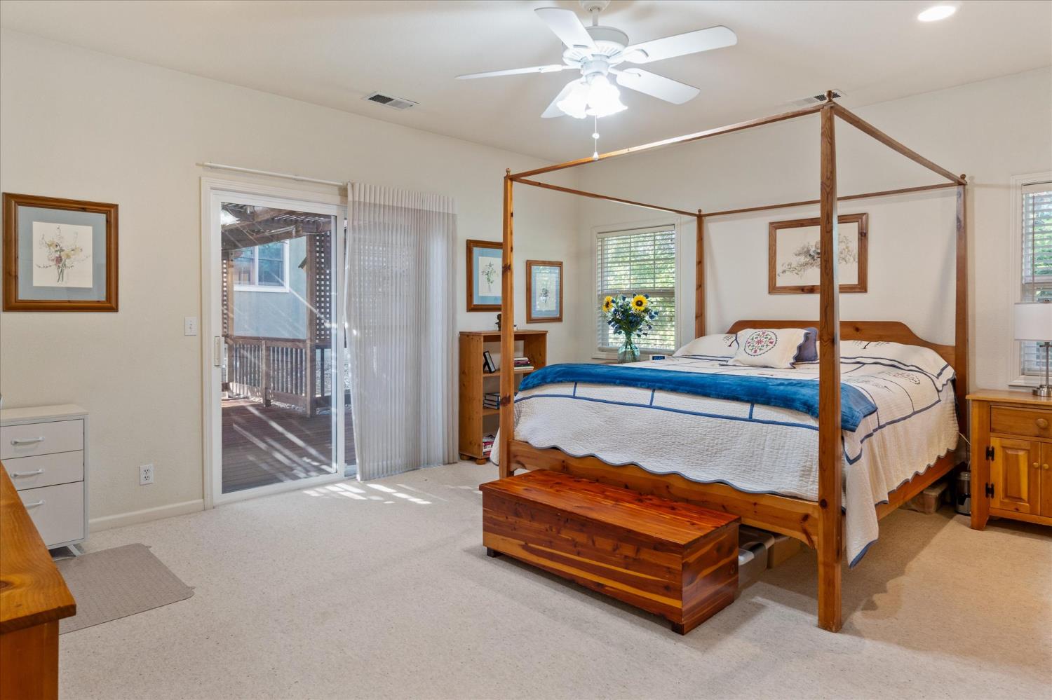 476 Fiddler Court Angels Camp, CA 95222 - Photo 18 of 40 a bedroom with a bed and a chandelier