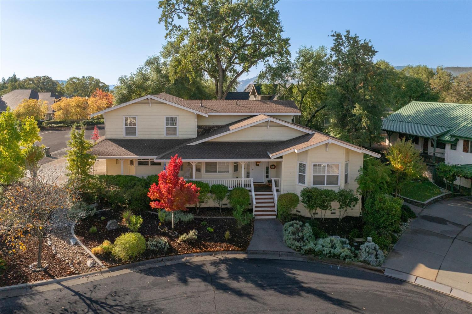 476 Fiddler Court Angels Camp, CA 95222 - Photo 2 of 40 a front view of a house with a yard and fountain in middle