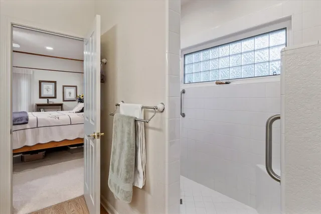 a en suite bathroom with a shower and a sink
