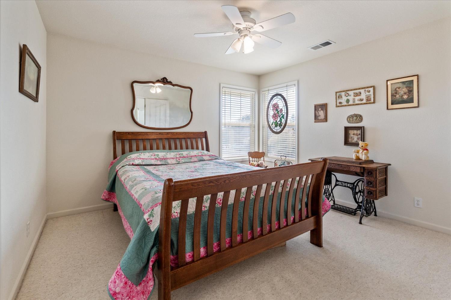 476 Fiddler Court Angels Camp, CA 95222 - Photo 25 of 40 a bedroom with a bed and a chandelier