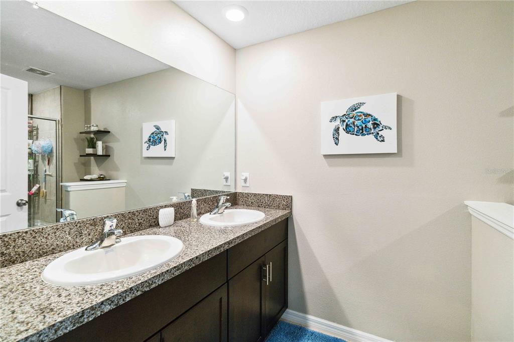 14339 Easy Goer Street Ruskin, FL 33573 - Photo 39 of 49 a bathroom with a granite countertop double vanity sink and a mirror