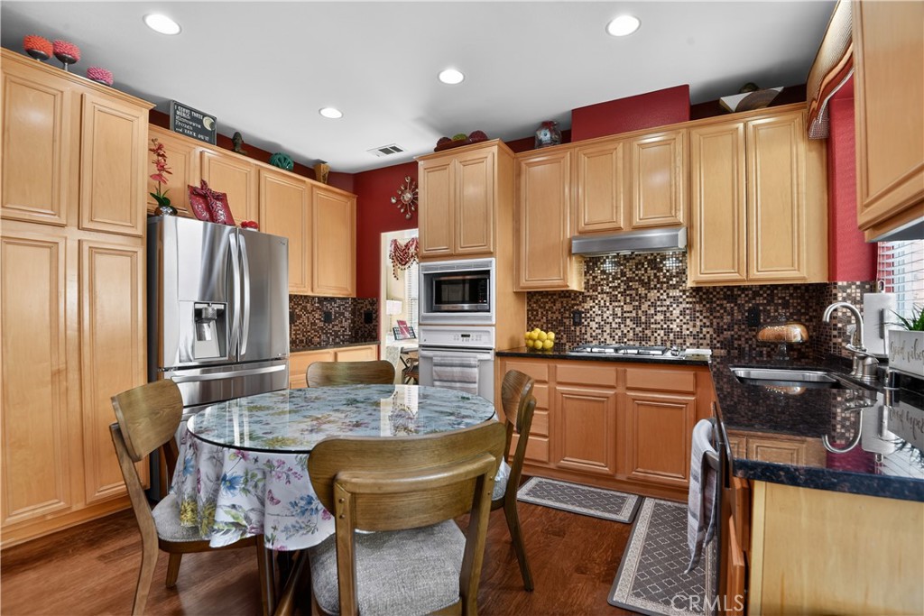 2621 Fallen Leaf Court Simi Valley, CA 93063 - Photo 22 of 58 a kitchen with sink a refrigerator and chairs