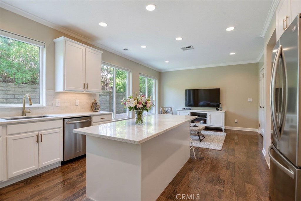 2621 Fallen Leaf Court Simi Valley, CA 93063 - Photo 25 of 58 a large kitchen with kitchen island a large counter top space appliances and a center